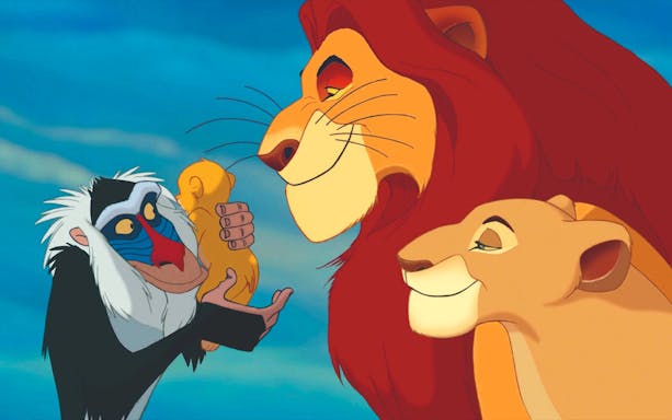 Rafiki holding baby Simba with Mufasa and Sarabi in the Lion King scene.