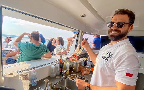Guests enjoying breakfast on Sopot Cruise with a view of the sea.