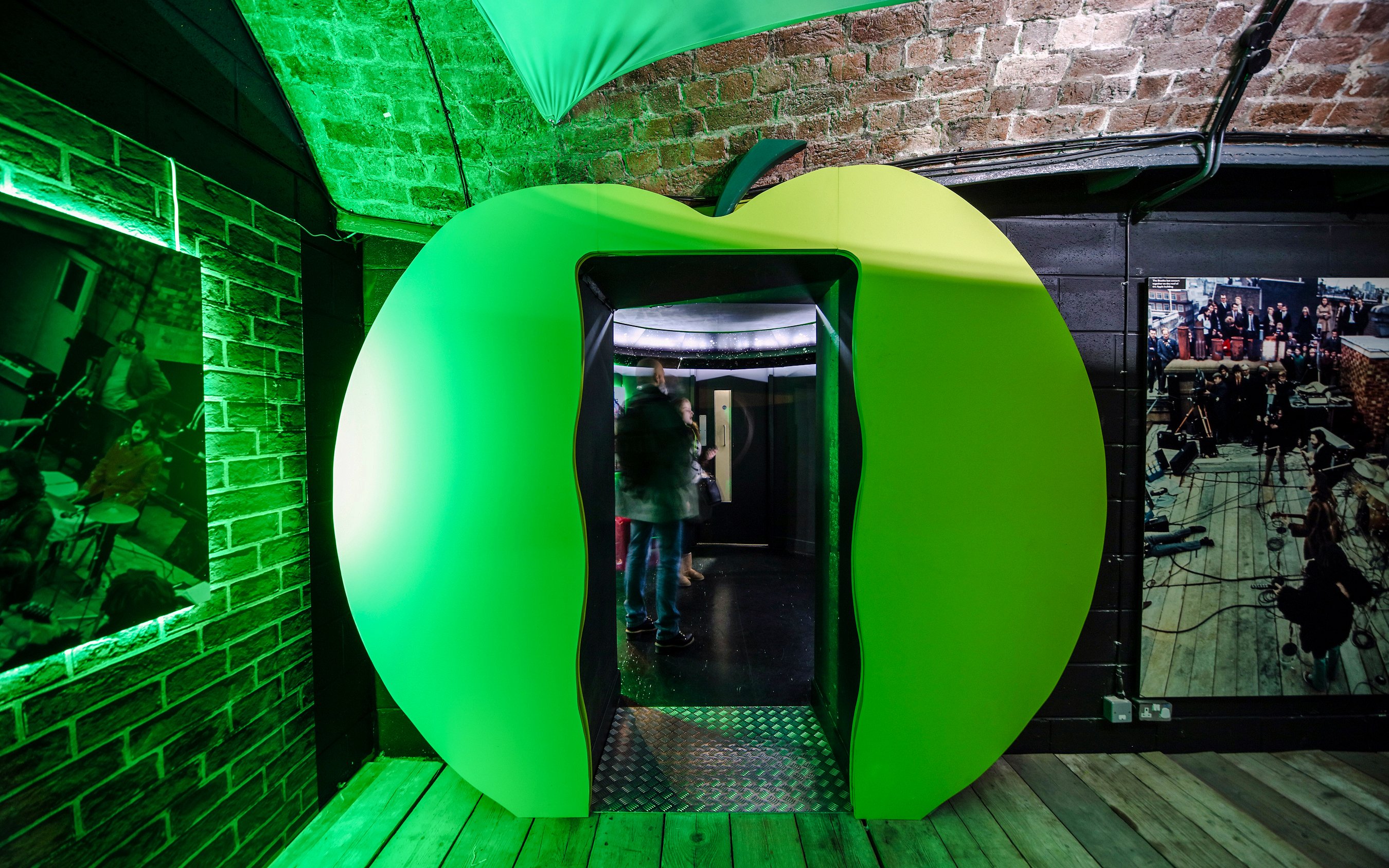 Green apple-shaped entrance at The Beatles Story exhibit in Liverpool.