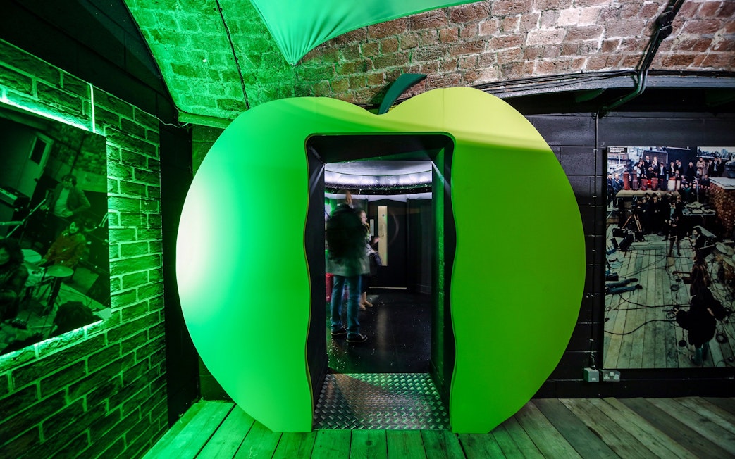 Green apple-shaped entrance at The Beatles Story exhibit in Liverpool.