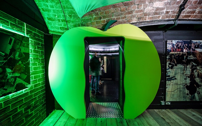 Green apple-shaped entrance at The Beatles Story exhibit in Liverpool.