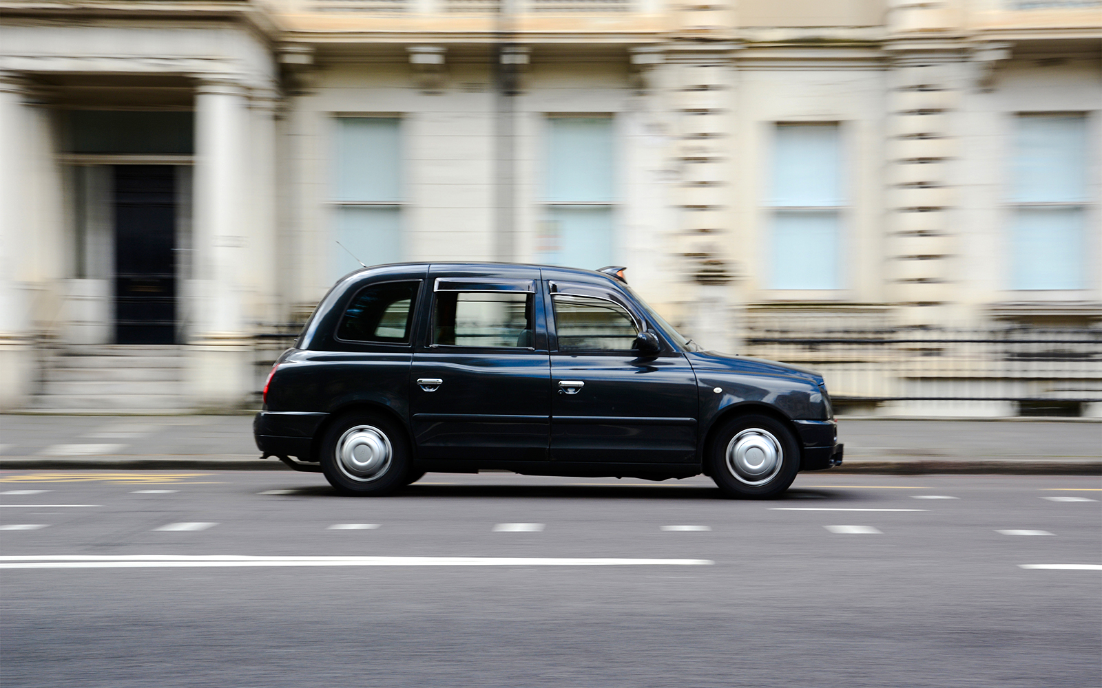 London black cab driving on a city street.