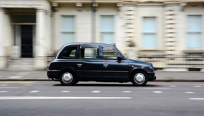 London black cab driving on a city street.