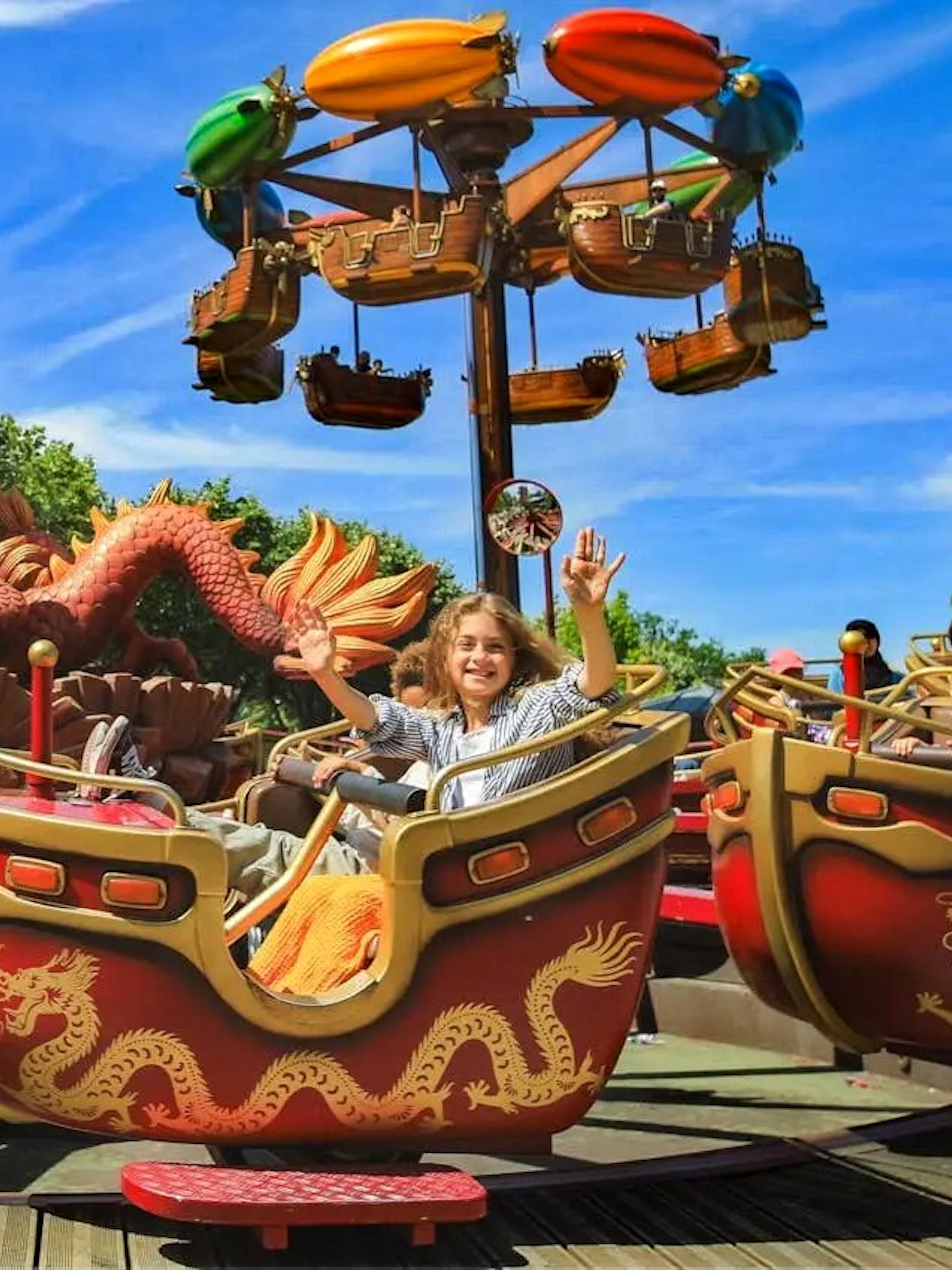 Visitors enjoying a dragon-themed ride at Jardin d'Acclimatation, Paris.