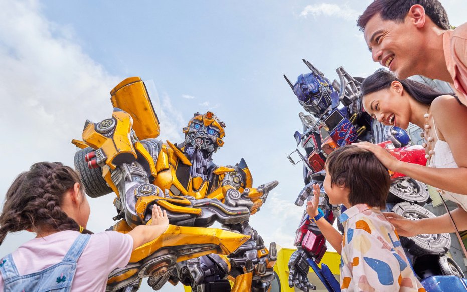 Visitors interacting with Transformers characters at Universal Studios Singapore.