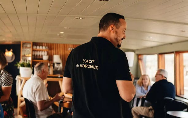 Guide giving live commentary on Bordeaux River Cruise.