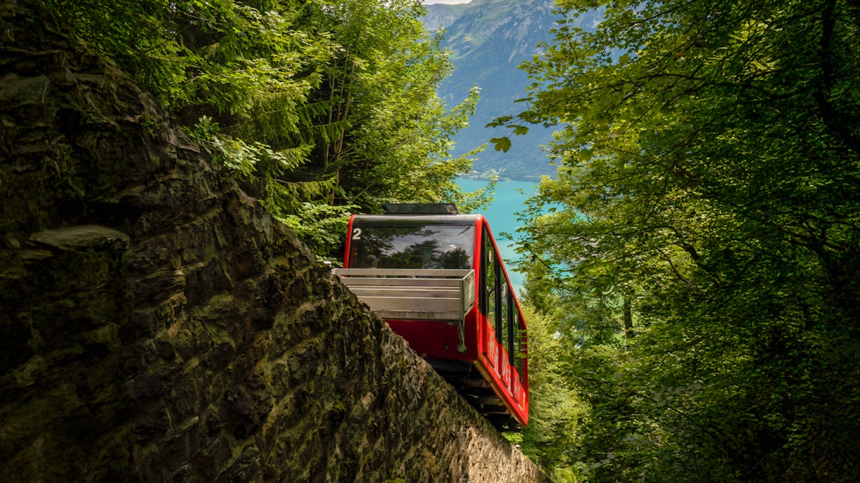 Harder Kulm funicular ascending through lush Swiss Alps with panoramic views of Interlaken.