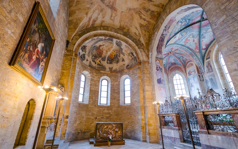 Basilica of St George interior with frescoed ceilings and arched windows.