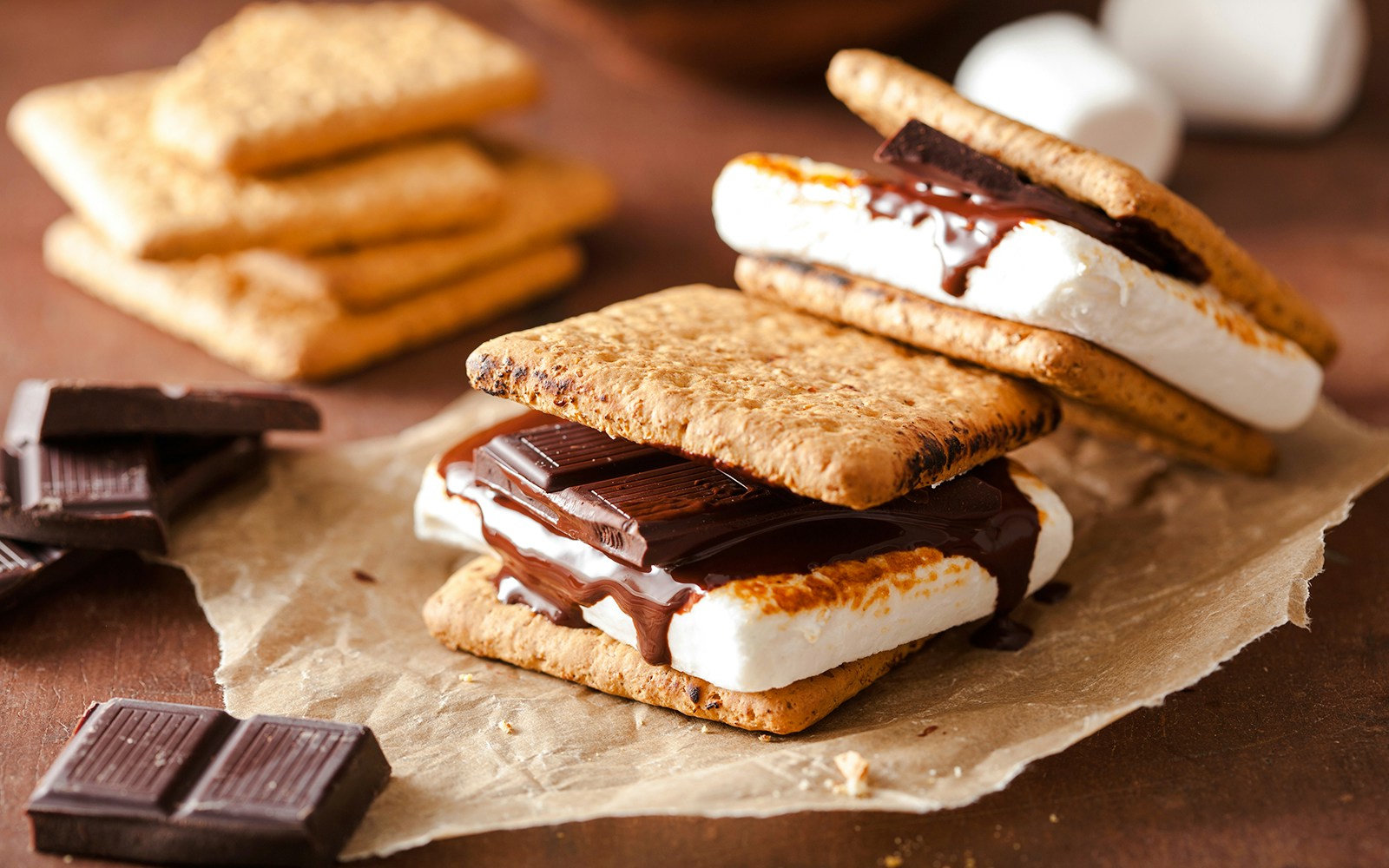 Toasted marshmallow and chocolate between graham crackers, classic s’mores dessert.