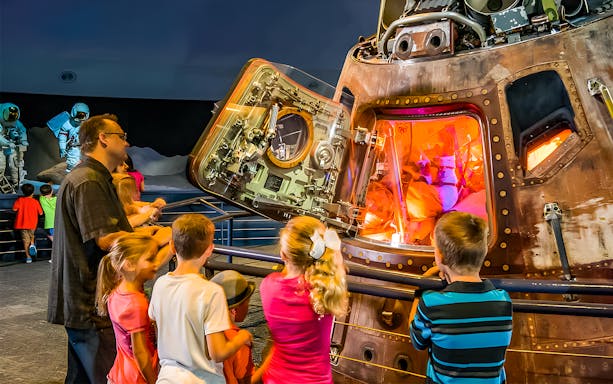Children engaging with interactive exhibits at Houston Space Center.