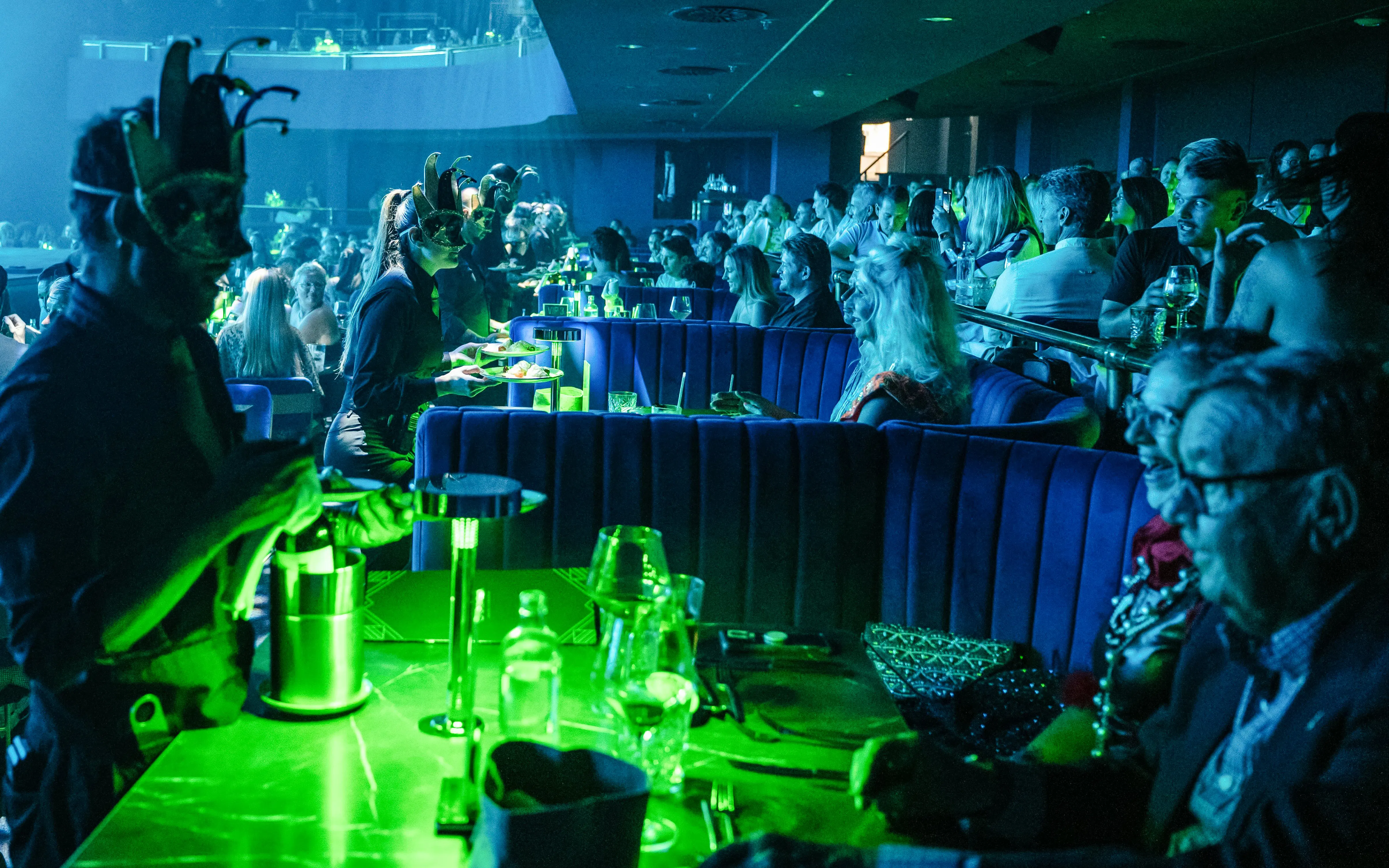 Audience enjoying a performance at Sala Scala Gran Canaria with masked servers.
