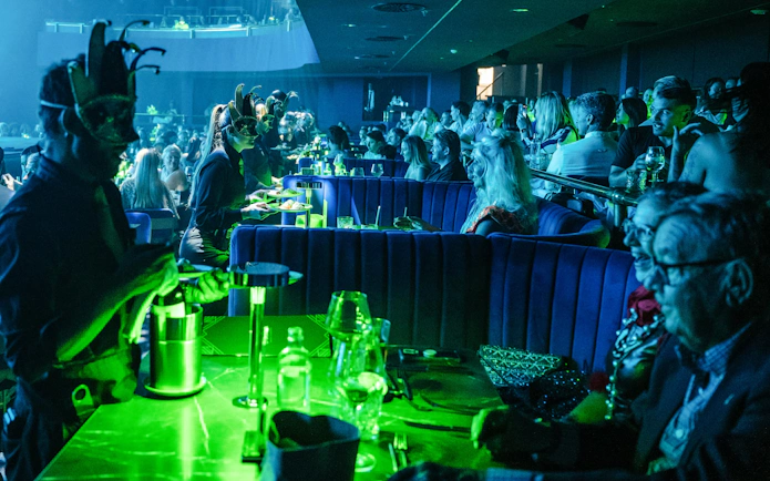 Audience enjoying a performance at Sala Scala Gran Canaria with masked servers.