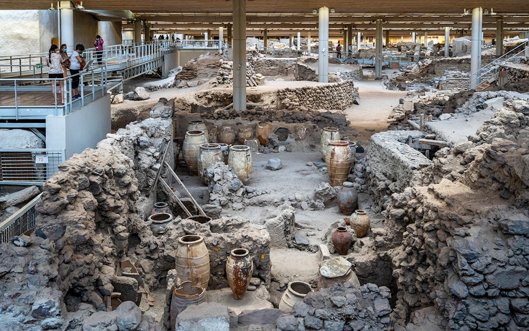 Akrotiri Excavations interior with ancient pottery and ruins in Santorini.