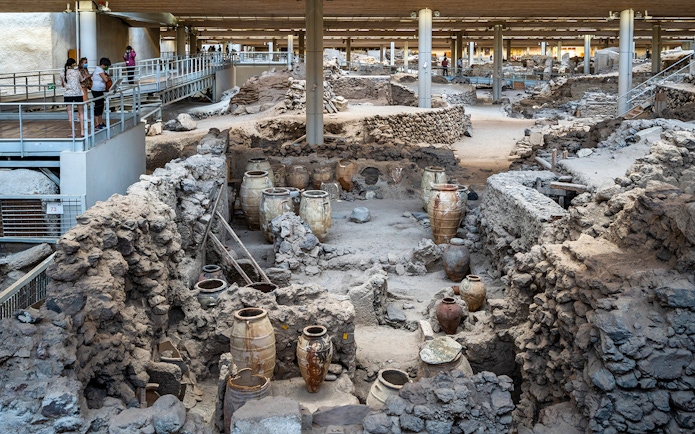 Akrotiri Excavations interior with ancient pottery and ruins in Santorini.