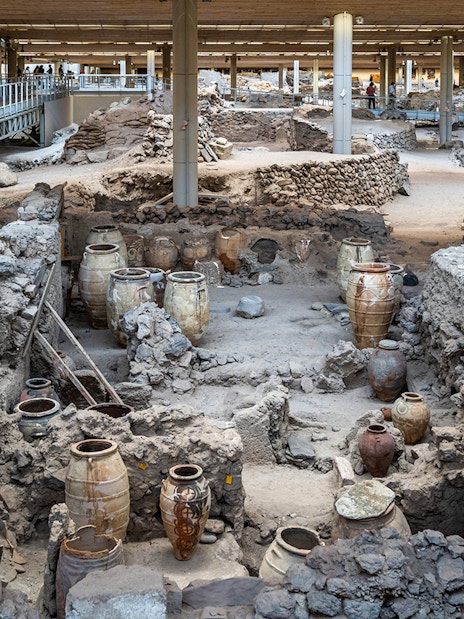 Akrotiri Excavations interior with ancient pottery and ruins in Santorini.