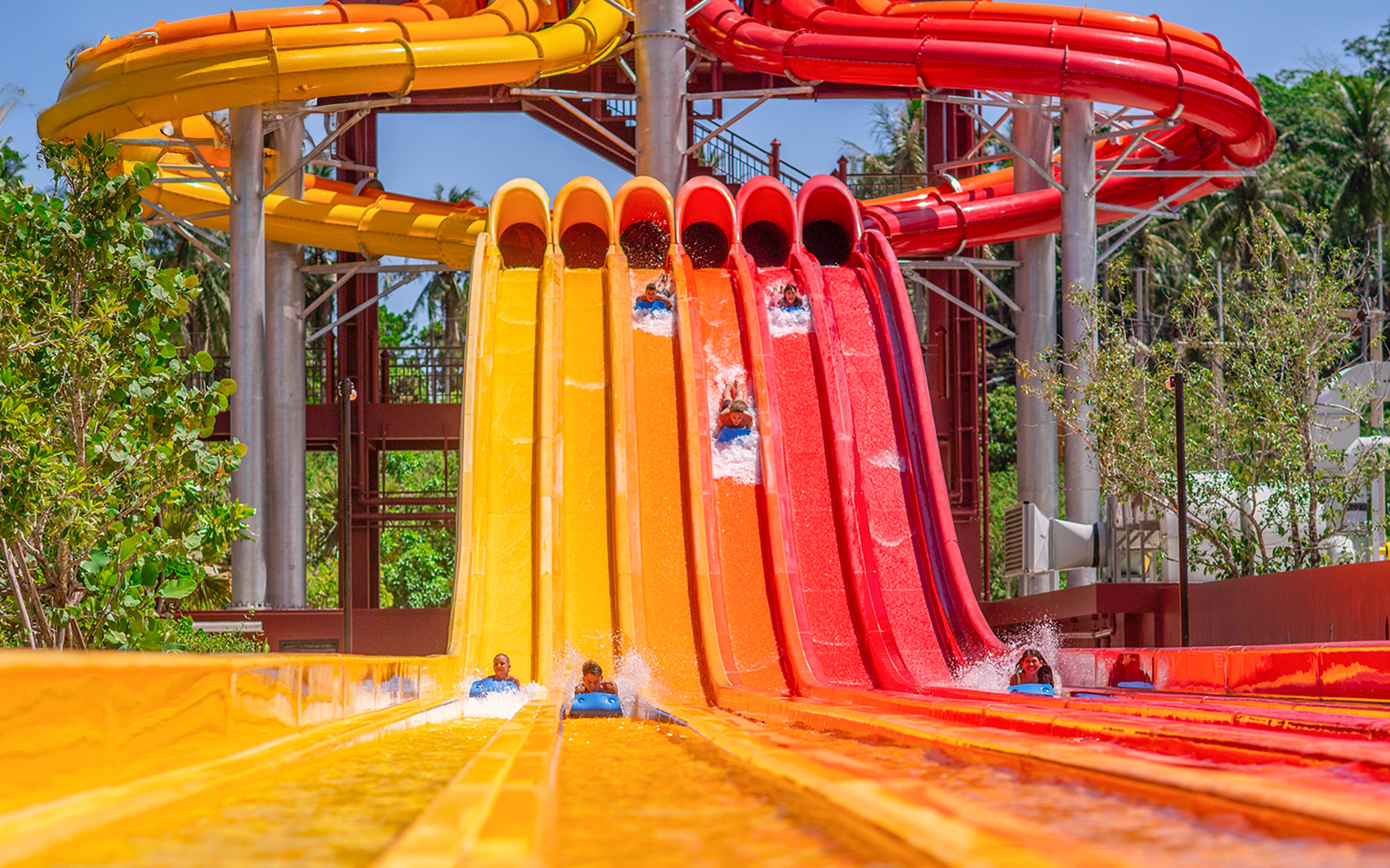 Riders on colorful water slides at Racing Nagas, Andamanda Phuket.