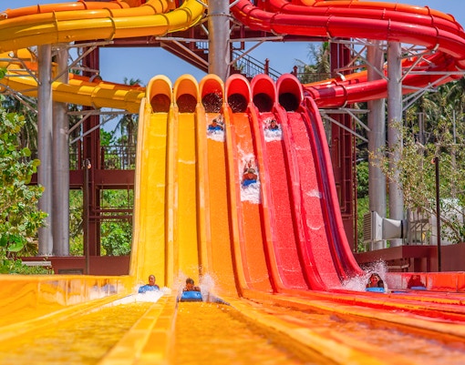 Riders on colorful water slides at Racing Nagas, Andamanda Phuket.