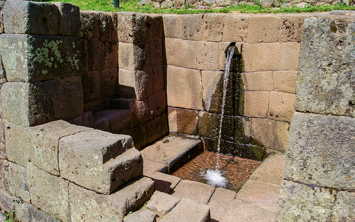 Ceremonial stone fountain with flowing water at Machu Picchu, Peru.