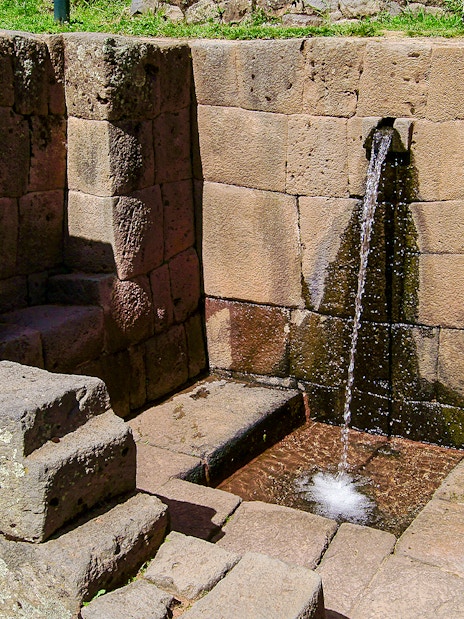 Ceremonial stone fountain with flowing water at Machu Picchu, Peru.