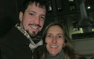 Couple enjoying Geneva Murder Mystery self-guided city exploration game at night.