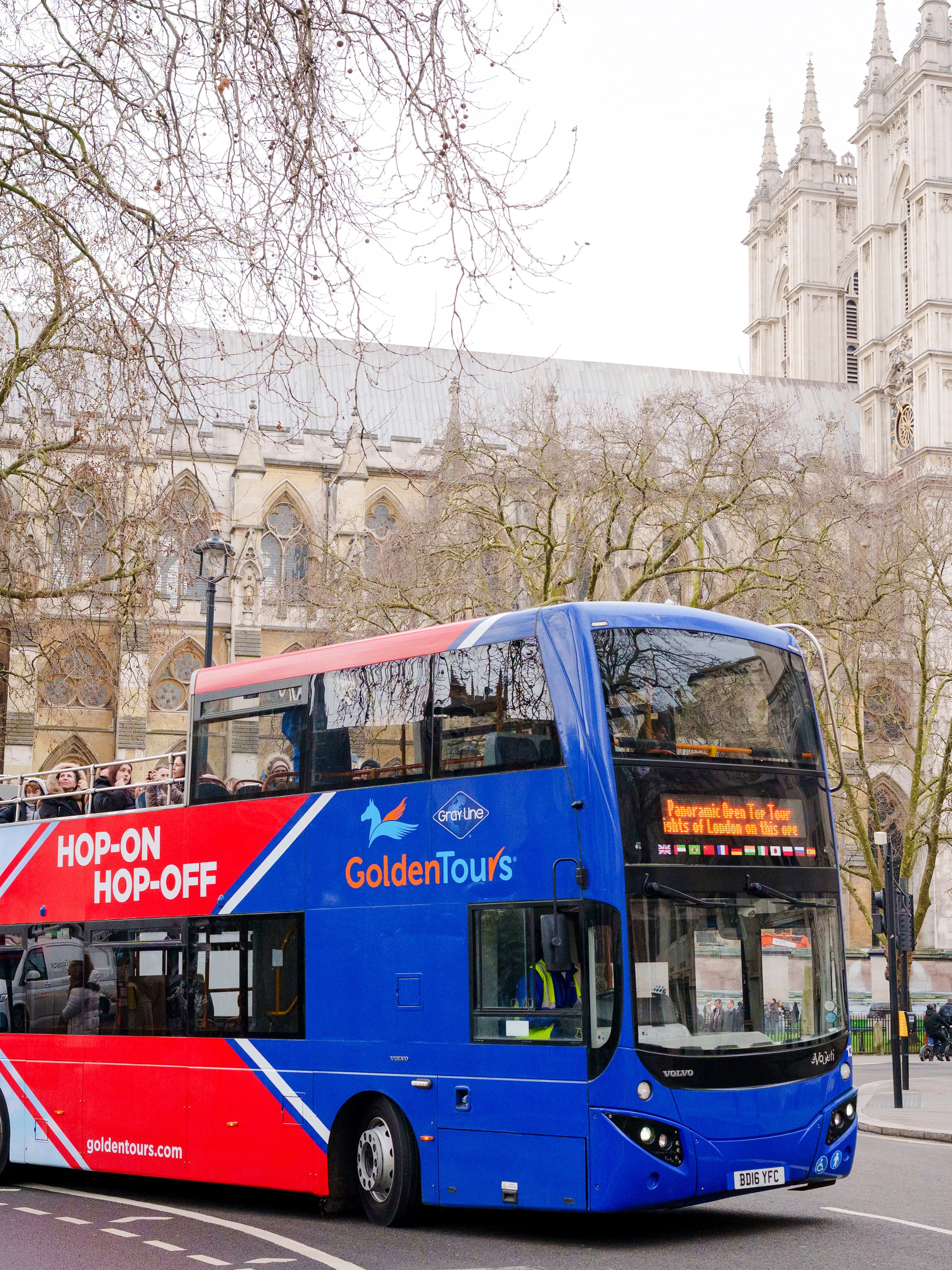Golden Tours hop-on hop-off bus near Westminster Abbey, London.