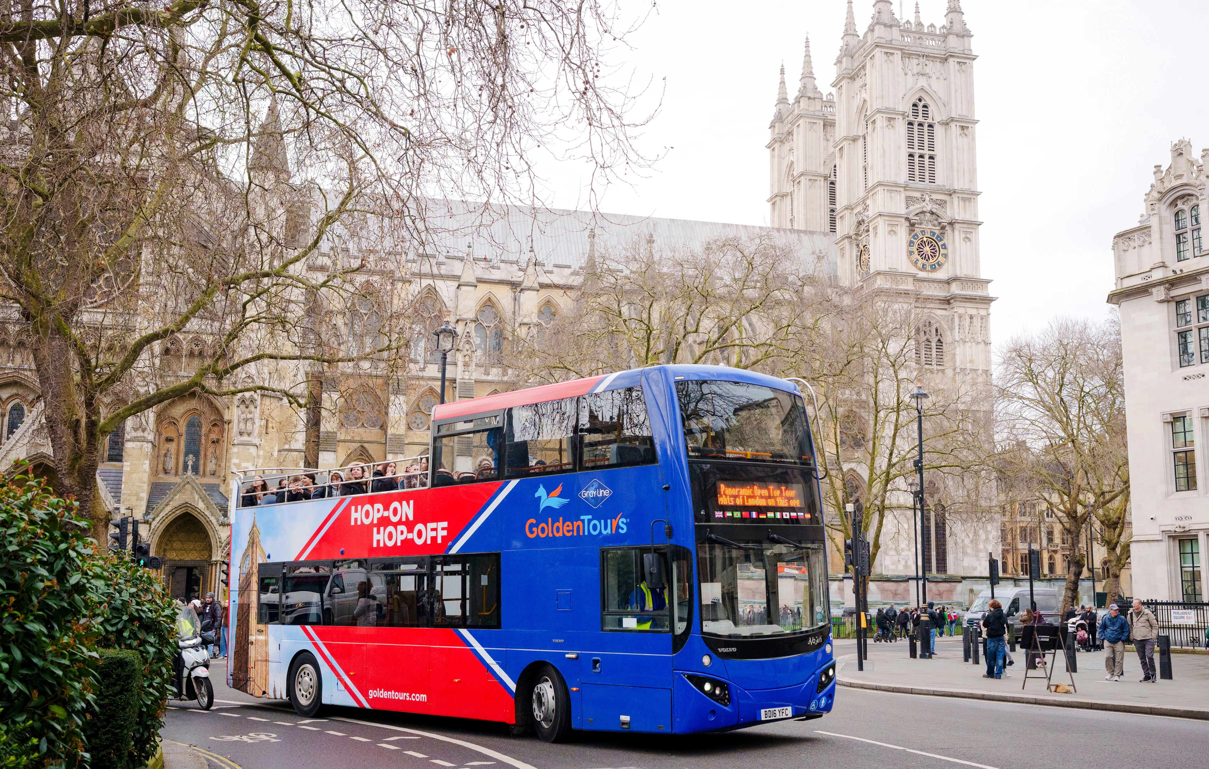 Golden Tours hop-on hop-off bus near Westminster Abbey, London.