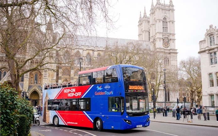 Golden Tours hop-on hop-off bus near Westminster Abbey, London.
