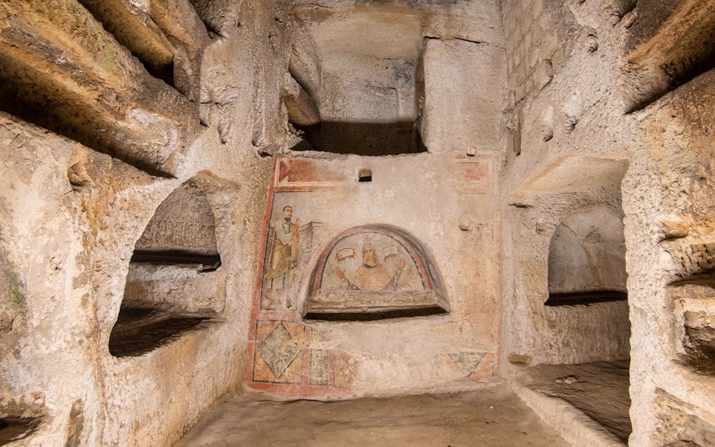 Catacombs of San Gennaro frescoes and burial niches in Naples, Italy.