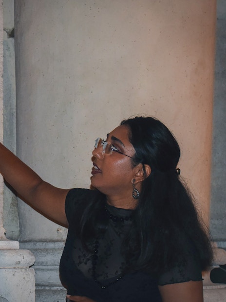 Person explaining a skeleton engraving on a wall during a ghost walking tour in Rome.
