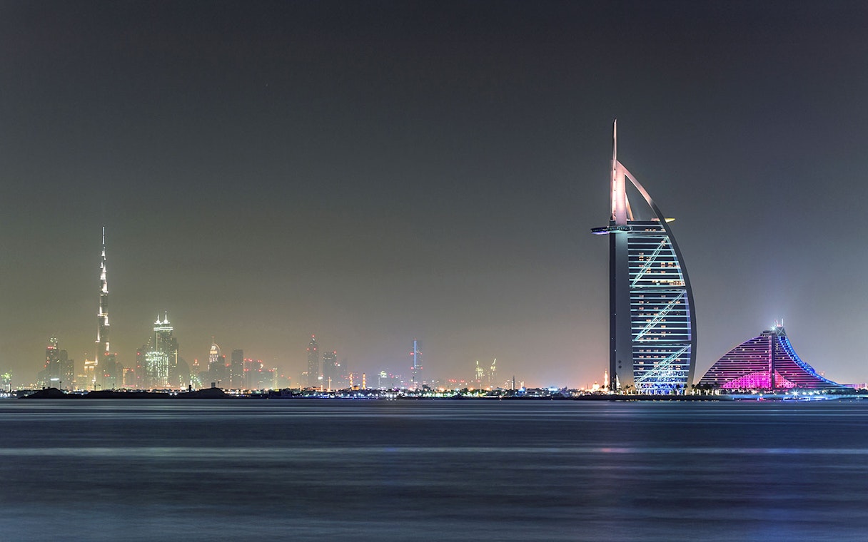 Burj Al Arab and Dubai skyline at night from Aura Skypool.