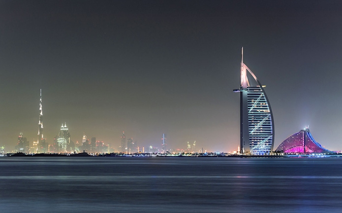 Burj Al Arab and Dubai skyline at night from Aura Skypool.