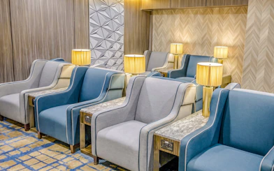 Seating area with armchairs and lamps at Plaza Premium Lounge, Terminal 1, Toronto Pearson Airport.