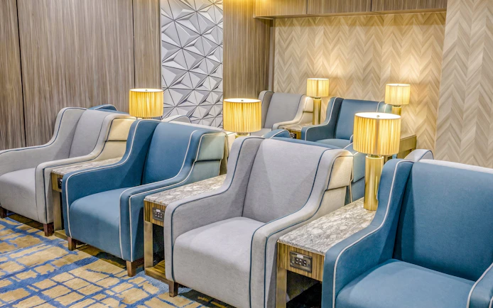 Seating area with armchairs and lamps at Plaza Premium Lounge, Terminal 1, Toronto Pearson Airport.