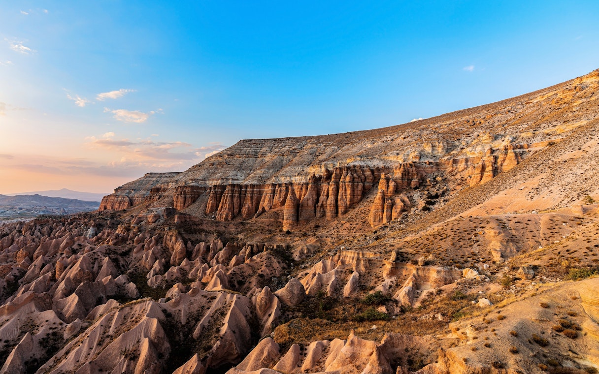 Goreme's Red Valley rock formations in Cappadocia, Turkey, under a clear blue sky.