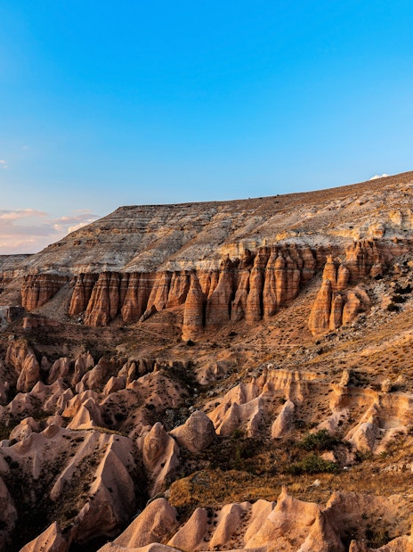 Goreme's Red Valley rock formations in Cappadocia, Turkey, under a clear blue sky.
