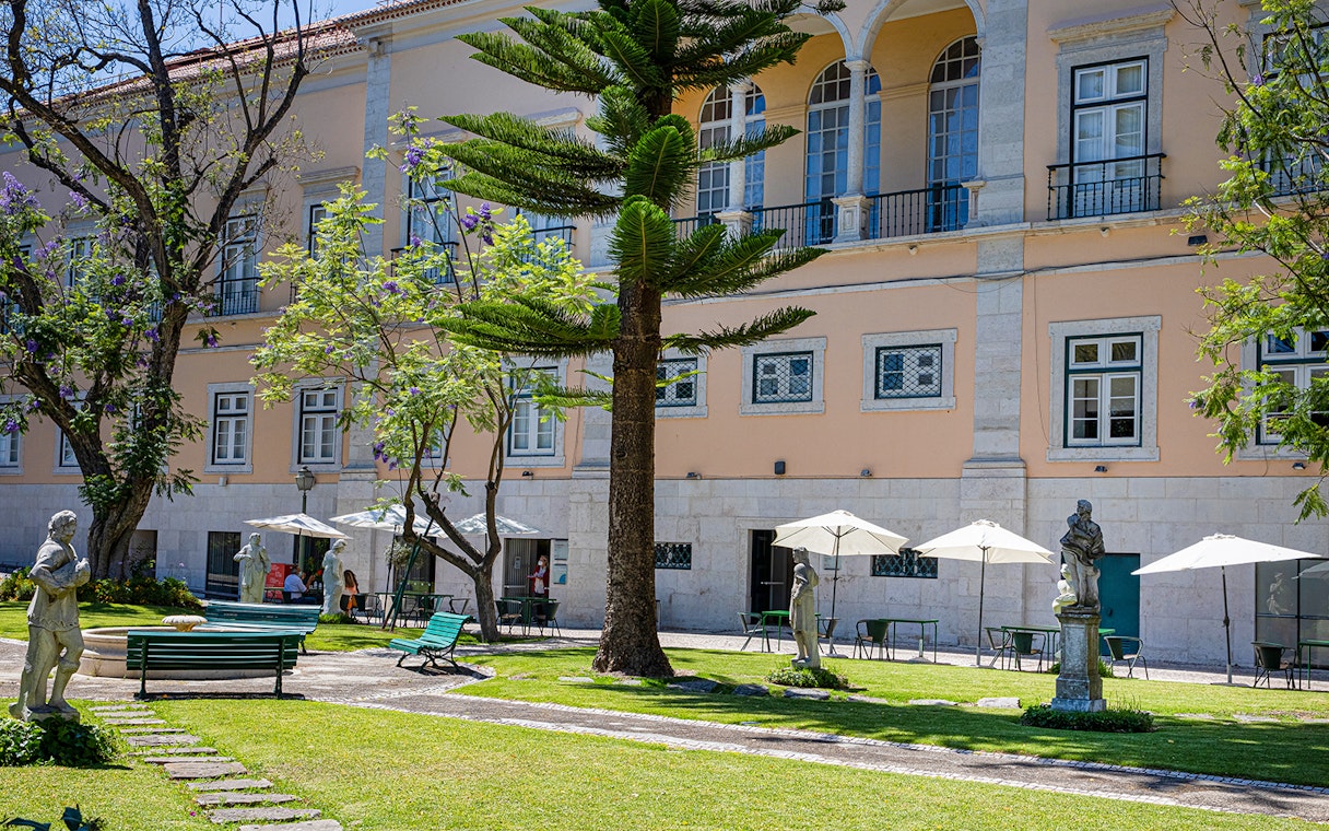 Courtyard with statues and seating at the National Museum of Ancient Art, Lisbon.