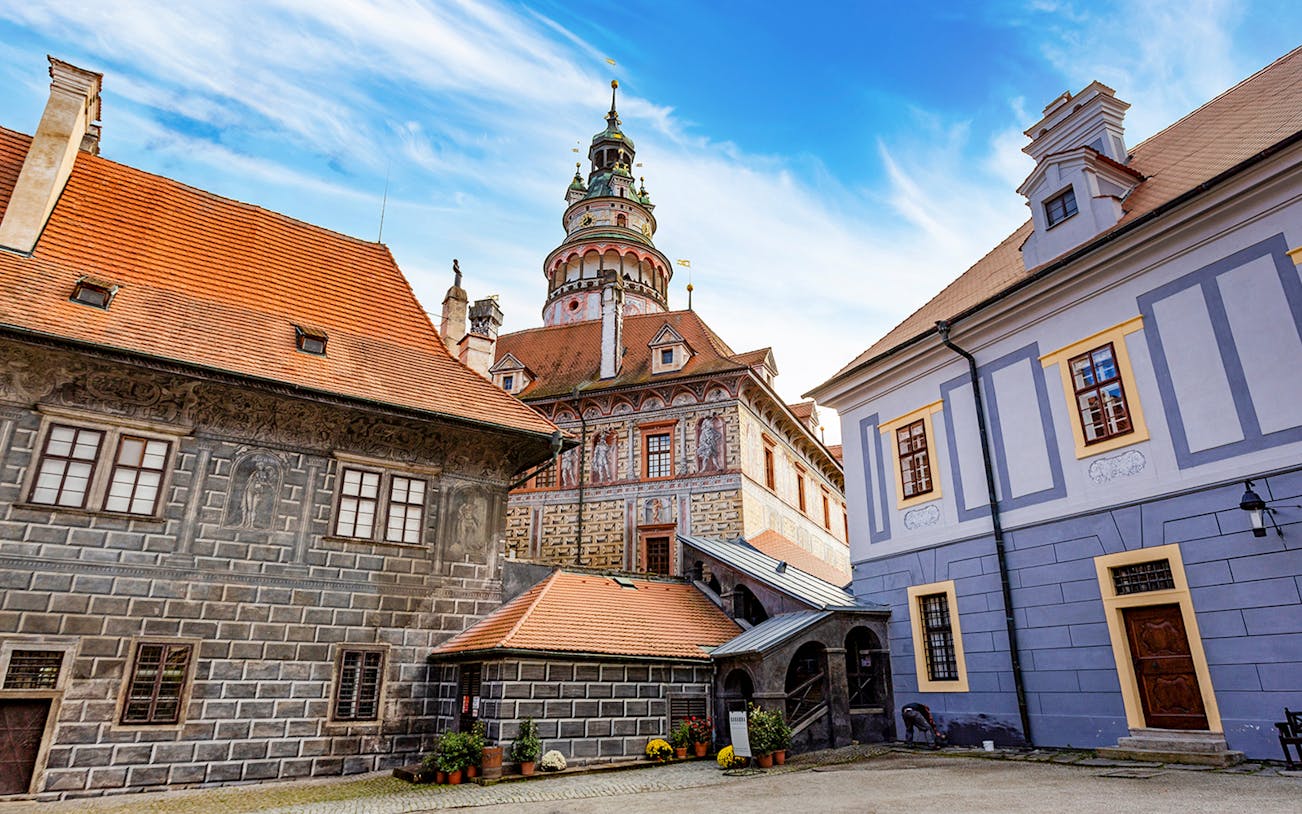 Český Krumlov Castle exterior with tower and historic buildings, Czech Republic.