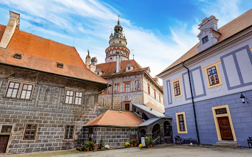 Český Krumlov Castle exterior with tower and historic buildings, Czech Republic.