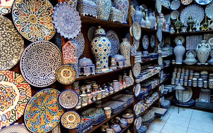 Ceramic plates and pottery in a shop at Fes Old Medina souks, Morocco.