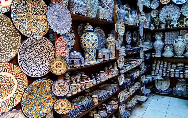 Ceramic plates and pottery in a shop at Fes Old Medina souks, Morocco.