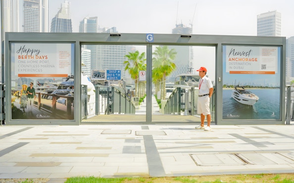 Marasi Marina entrance with yachts and skyscrapers in Dubai.