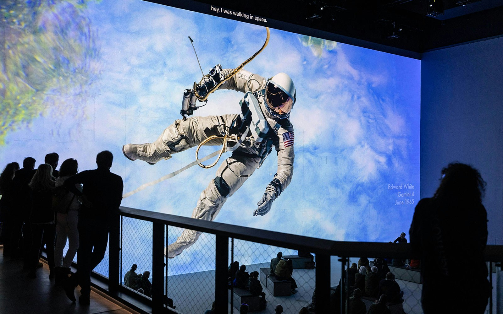 Astronaut floating in space exhibit at The Moonwalkers immersive experience.