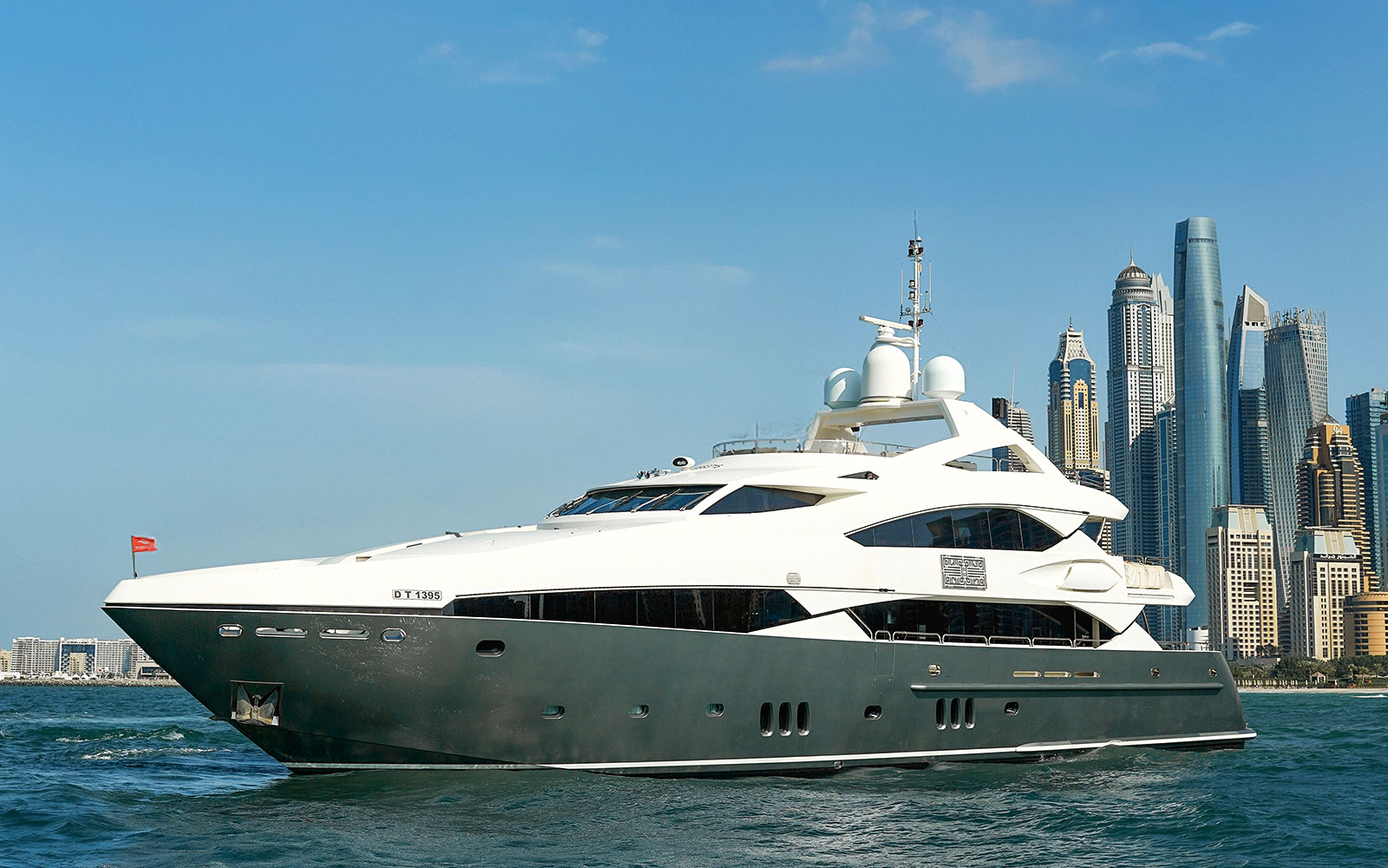 Superyacht cruising near Dubai skyline, offering gourmet dining and live music experience.