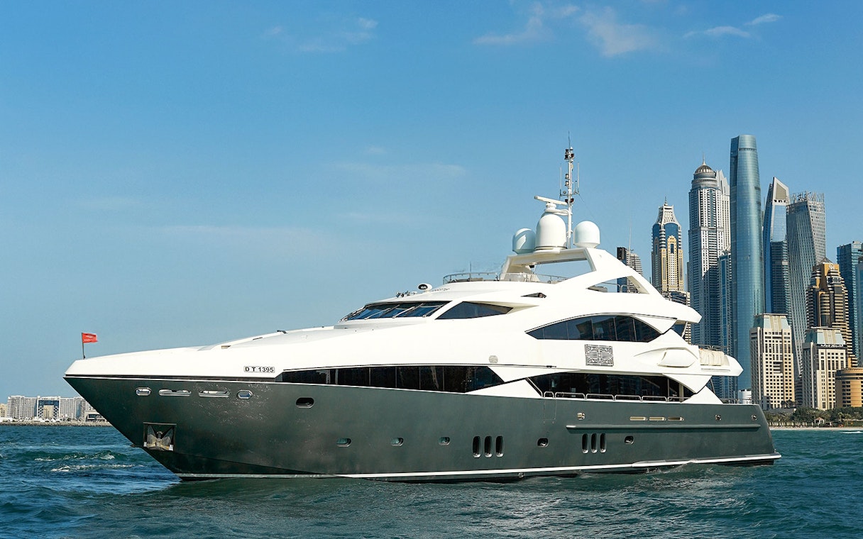 Superyacht cruising near Dubai skyline, offering gourmet dining and live music experience.