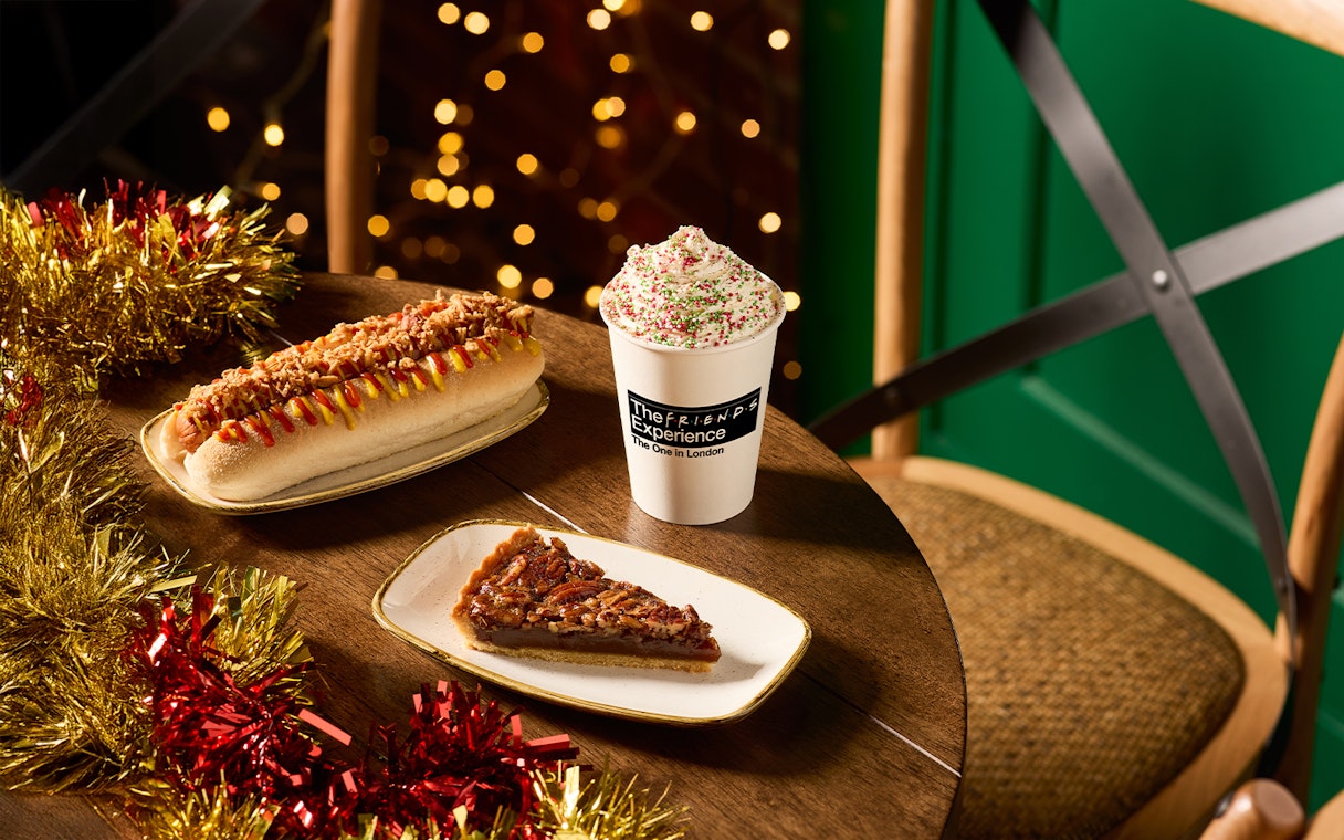 Hot dog, pecan pie slice, and festive drink at The FRIENDS™ Experience in London.