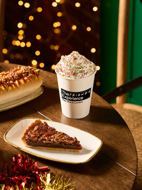 Hot dog, pecan pie slice, and festive drink at The FRIENDS™ Experience in London.