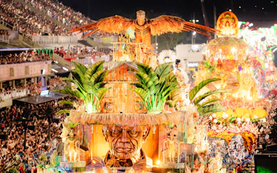 Samba parade float with vibrant costumes and large bird sculpture at Rio Carnival, Rio de Janeiro.