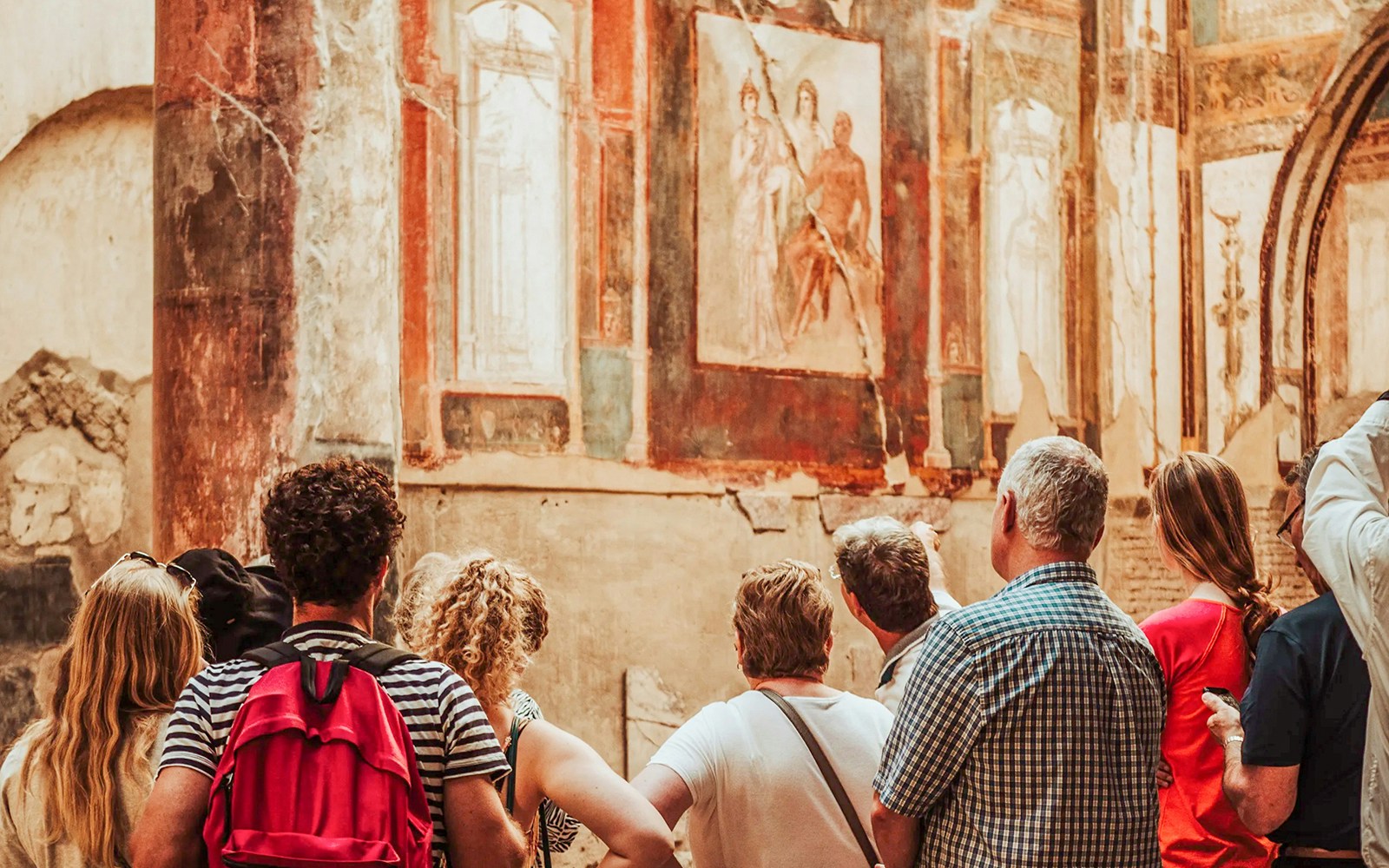 Herculaneum ruins with expert guide explaining ancient Roman architecture.