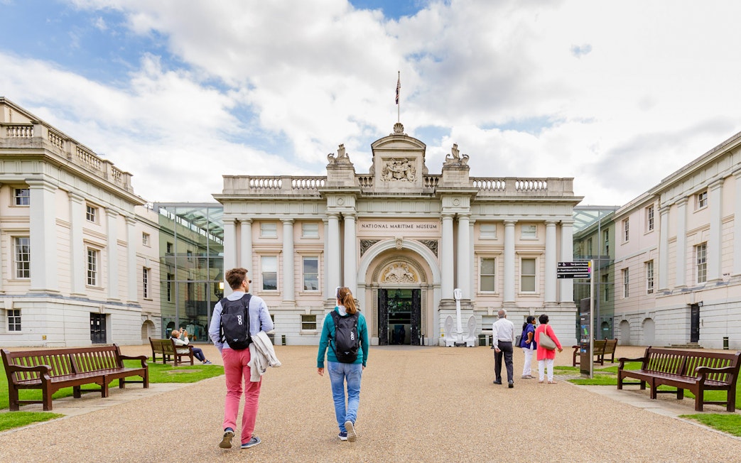Visitors walking towards the National Maritime Museum entrance in London.