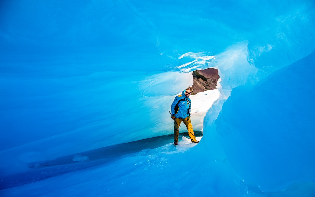 Tourist exploring ice caves at Big Ice, Perito Moreno Glacier, Argentina.